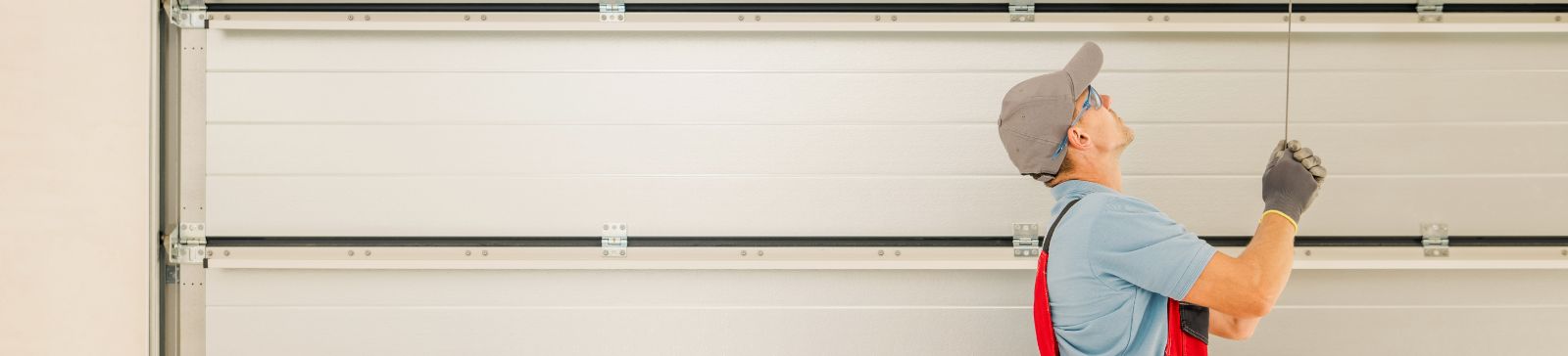 Technician performing garage door spring repair in a Chicago residential garage